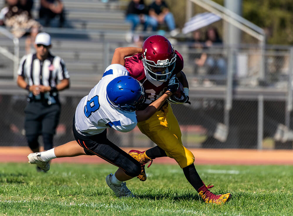 Football player tackling an opponent